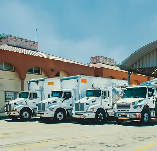 TRESAL mixed fleet at operating yard: box-truck rigid trucks and stainless steel rigid tank trucks for chemical transport