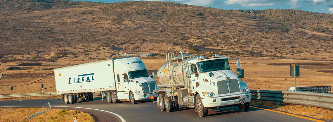 TRESAL fleet on Mexican Altiplano highway: stainless steel tank truck and dry box for bulk chemical and hazardous materials transport